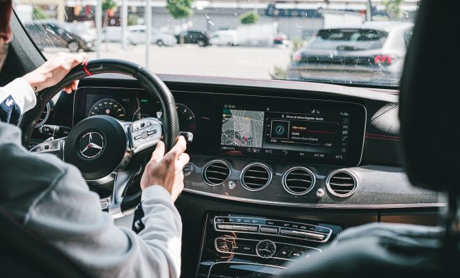 person in gray long sleeve shirt driving car